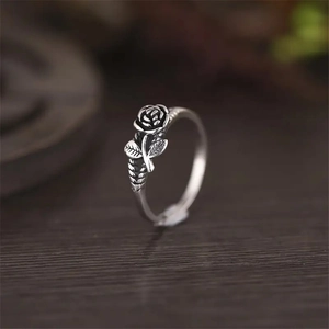 Macro shot of vintage silver-tone 3D rose ring with detailed petals and leaves