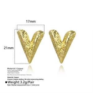 Detail view of hammered 18k gold heart earrings with textured finish and precise measurements