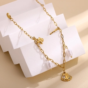 Detail of gold starfish and shell pendant necklace with freshwater pearl and crystals