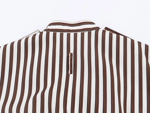 Detail of striped shirt back collar and shoulder stitching with brown and black patterns