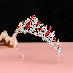 Detail view of Baroque silver crown featuring red rhinestones and secure end loops