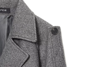 Detailed close-up of grey wool coat lapel and shoulder button craftsmanship details