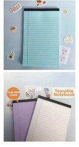 Detail view of colorful A5 writing pads with easy-tear line and top black glue binding