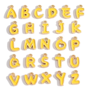 Detailed set of 26 yellow enamel and gold alloy alphabet charms for DIY jewelry making