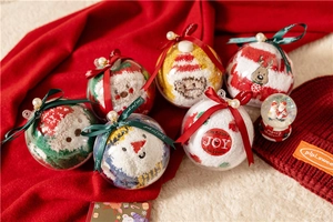 Detail of Christmas coral fleece socks in hanging gift globes with festive ribbons