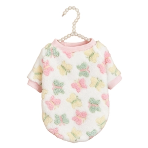 Detailed view of white plush dog sweater with colorful butterfly patterns and pink ribbed trim