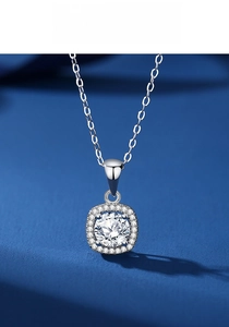 Macro view of princess-cut moissanite pendant with halo setting on a silver chain