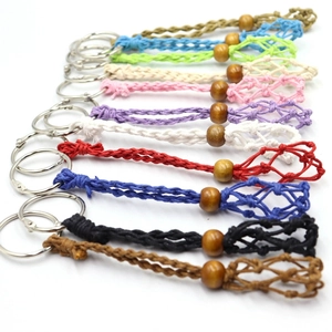 Detailed shot of handmade woven mesh keychains in multiple colors with wooden bead detail