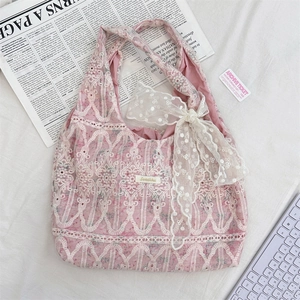 Detailed shot of pink lace tote bag with bow decoration and sweet vintage texture