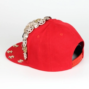 Side view detail of red snapback cap featuring metallic star and coin charms