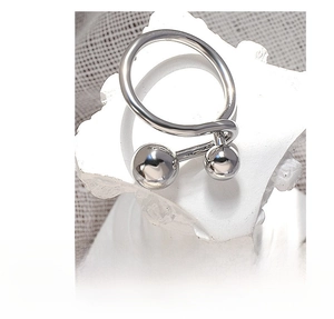 Macro shot of minimalist titanium steel ring with double ball open design on stone