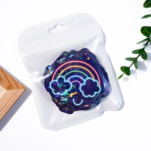 Macro shot of laser holographic rainbow and cloud stickers in a clear sealed bag