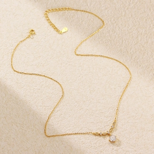 Macro shot of S925 sterling silver gold necklace featuring round zircon stone detail