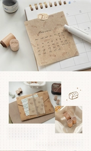 Close-up of cute wooden bakery stamps showing bread and coffee patterns on paper