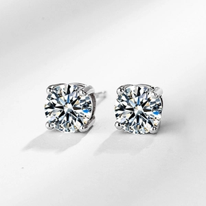 Macro shot of 925 sterling silver four-prong stud earrings with clear round cubic zirconia