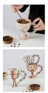 Macro shot of hand-painted leopard and zebra pattern ceramic goblets with handles