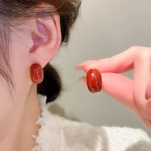 Close-up of vintage oval red agate earrings with elegant gold metal detailing