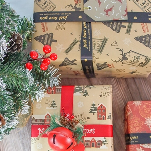 Christmas kraft wrapping paper rolls with festive deer patterns and elegant ribbons
