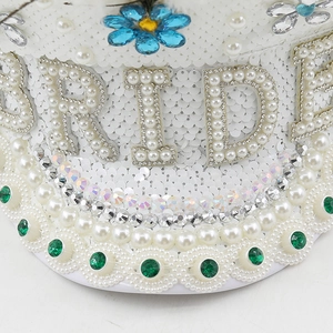 Detailed view of BRIDE pearls and sequins on a white luxury captain hat for wedding parties