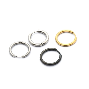 Close-up of minimalist hoop earrings in silver, gold, and black polished stainless steel