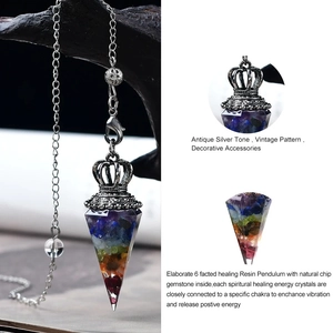 Macro detail of hexagonal resin pendulum with seven chakra natural crystal stones