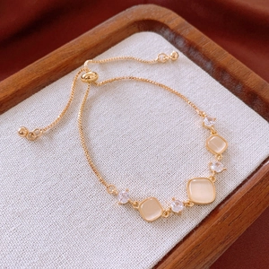Detailed shot of golden square cat eye stone bracelet with zircon accents and slide clasp