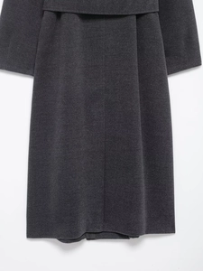 Detail of dark gray wool coat showing the back waist belt design and precise stitching