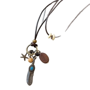 Bohemian style ethnic butterfly necklace with wood pendant and turquoise feather charm