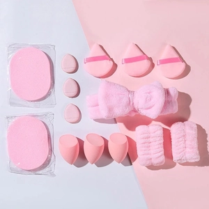 Flat lay of pink makeup set with sponges, powder puffs, headband and wristbands