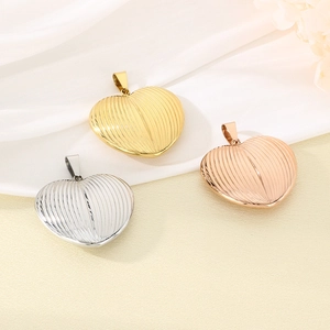 Detailed view of 18K gold-plated heart pendants with vertical striped texture finish