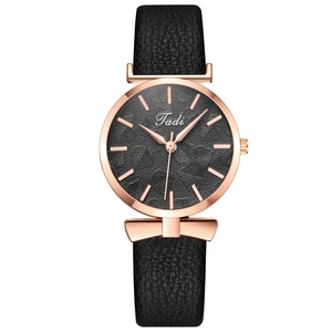 Elegant women's quartz watch with leaf pattern dial and rose gold bow accent on black strap