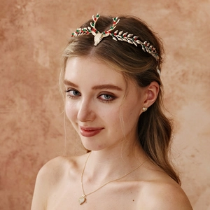 Detail of Christmas reindeer antler headband with heart necklace and earrings jewelry set