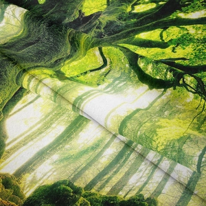 Macro detail of forest landscape tapestry showing green weave texture and soft fabric drape