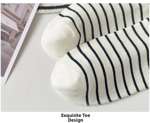 Detailed close-up of smooth seamless toe stitching on white cotton striped socks
