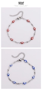 Detail of red and blue evil eye enamel bracelets with silver adjustable link chain