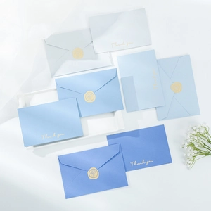 Detail of blue and white thank you cards with gold foil stamping and wax seal stickers
