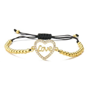 Detailed view of adjustable black cord bracelet with 18K gold-plated heart Love charm