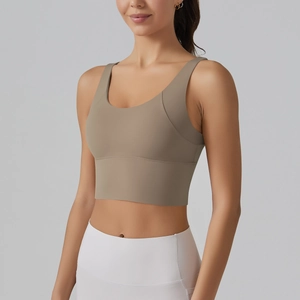 Detail of light brown v-back sports bra with seamless fabric and wide shoulder straps
