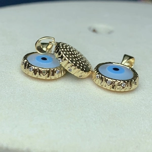 Golden evil eye pendant with sparkling rhinestones and textured details for DIY jewelry