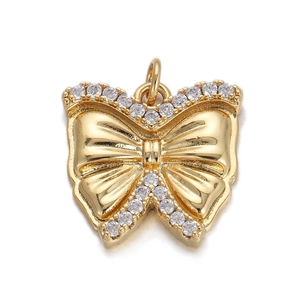 Macro shot of gold butterfly pendant with sparkling crystal trim and top connector loop