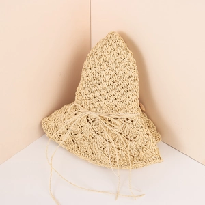 Detailed close-up of handmade straw sun hat with woven texture and decorative string