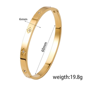 Gold stainless steel bangle with engraved star and crystal inlay details