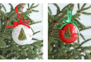 Close-up of red and white Christmas foam ball ornaments with silk bows and tree prints