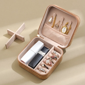 Detail of portable cork jewelry box with necklace hooks and velvet ring organizer