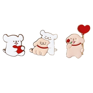 Three cute cartoon alloy puppy dog pins with red heart details in golden metal