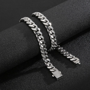 Detail of silver Cuban link chains with iced-out diamond-encrusted square clasp