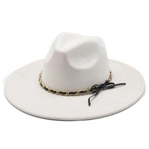Detail of white suede fedora hat with gold chain link and black ribbon bow accent