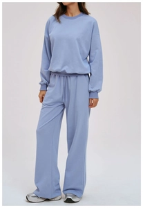 Detail of light blue crewneck sweatshirt set showing ribbed cuffs and soft knit texture