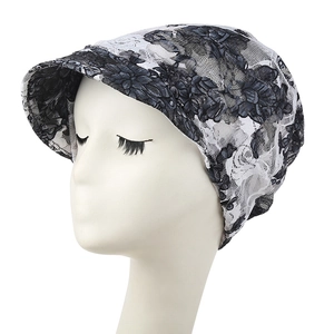 Women's summer lace beanie hat in black and white floral pattern with a visor design