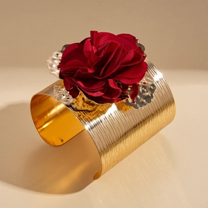 Golden brushed metal cuff bracelet featuring a large red fabric 3D rose decoration